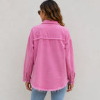 Back view of women's pink distressed denim shacket showing relaxed fit and frayed hem