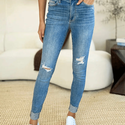 Side profile of Judy Blue skinny jeans showing moderate distressing and cuffed hem.
