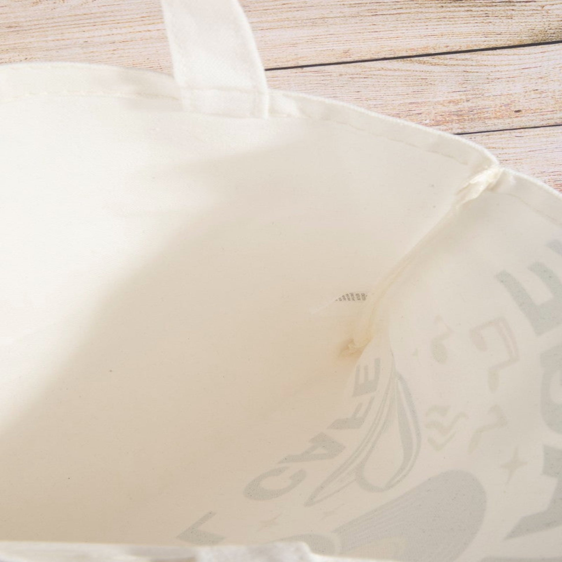 View of the roomy interior and lightweight fabric of the vinyl cafe tote bag