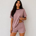 Model wearing dusty pink and deep brown horizontal striped short-sleeve lounge shorts set