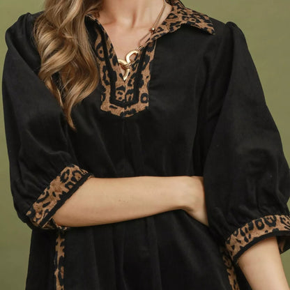 Close up shot of the unique contrast trim stitching on a black Umgee shift dress from Solazura Boutique