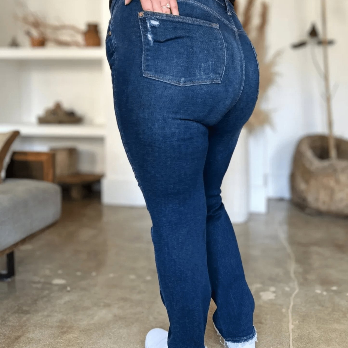 Full-length model shot of edgy dark wash straight-leg jeans.