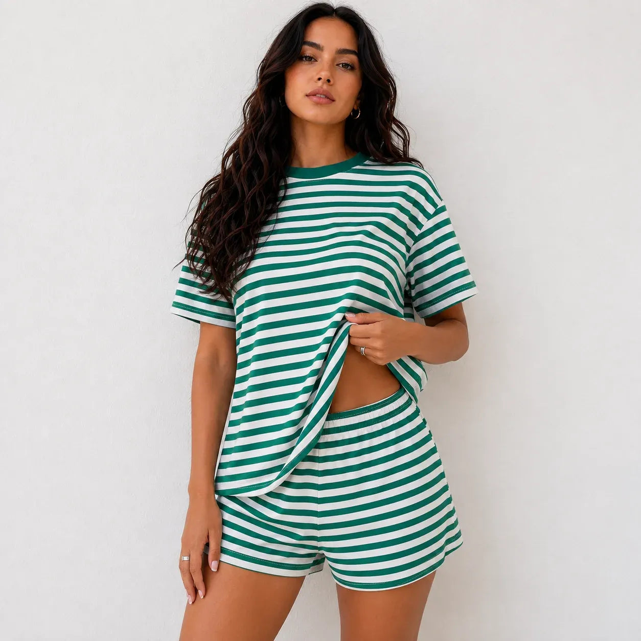 Woman wearing emerald green and white horizontal striped short-sleeve top and shorts lounge set