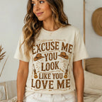 Woman modeling the natural "Excuse Me You Look Like You Love Me" graphic t-shirt with a relaxed casual western-inspired outfit.