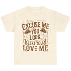 Natural graphic t-shirt featuring the "Excuse Me You Look Like You Love Me" western-inspired graphic with cowboy hats and guitars.