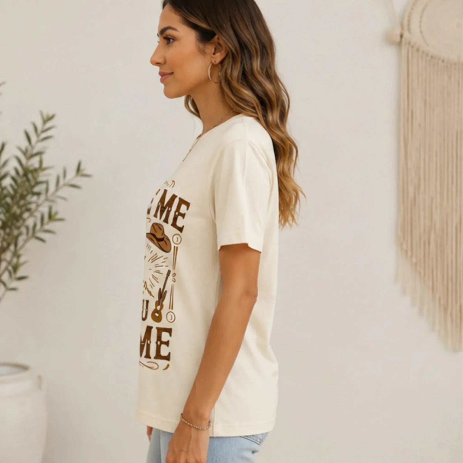 Side profile of a woman wearing the natural "Excuse Me You Look Like You Love Me" graphic t-shirt with short sleeves and relaxed fit.