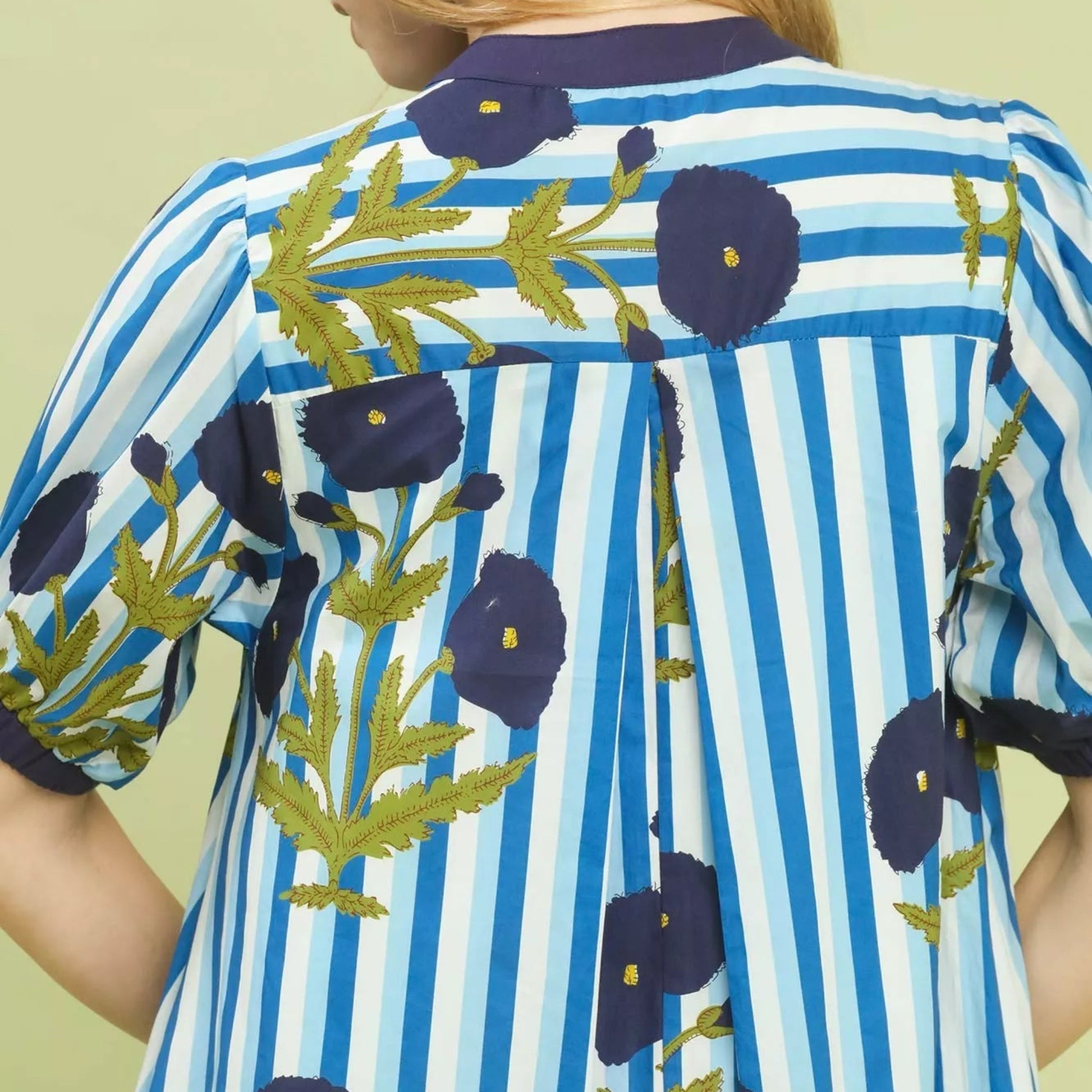 Close up texture shot of the ocean blue floral stripe contrast pattern fabric from Solazura Boutique