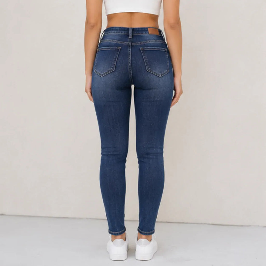 Fleece-lined mid-rise skinny jeans in blue shown from the back
