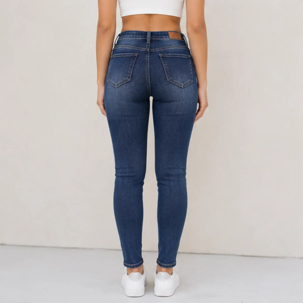 Fleece-lined mid-rise skinny jeans in blue shown from the back