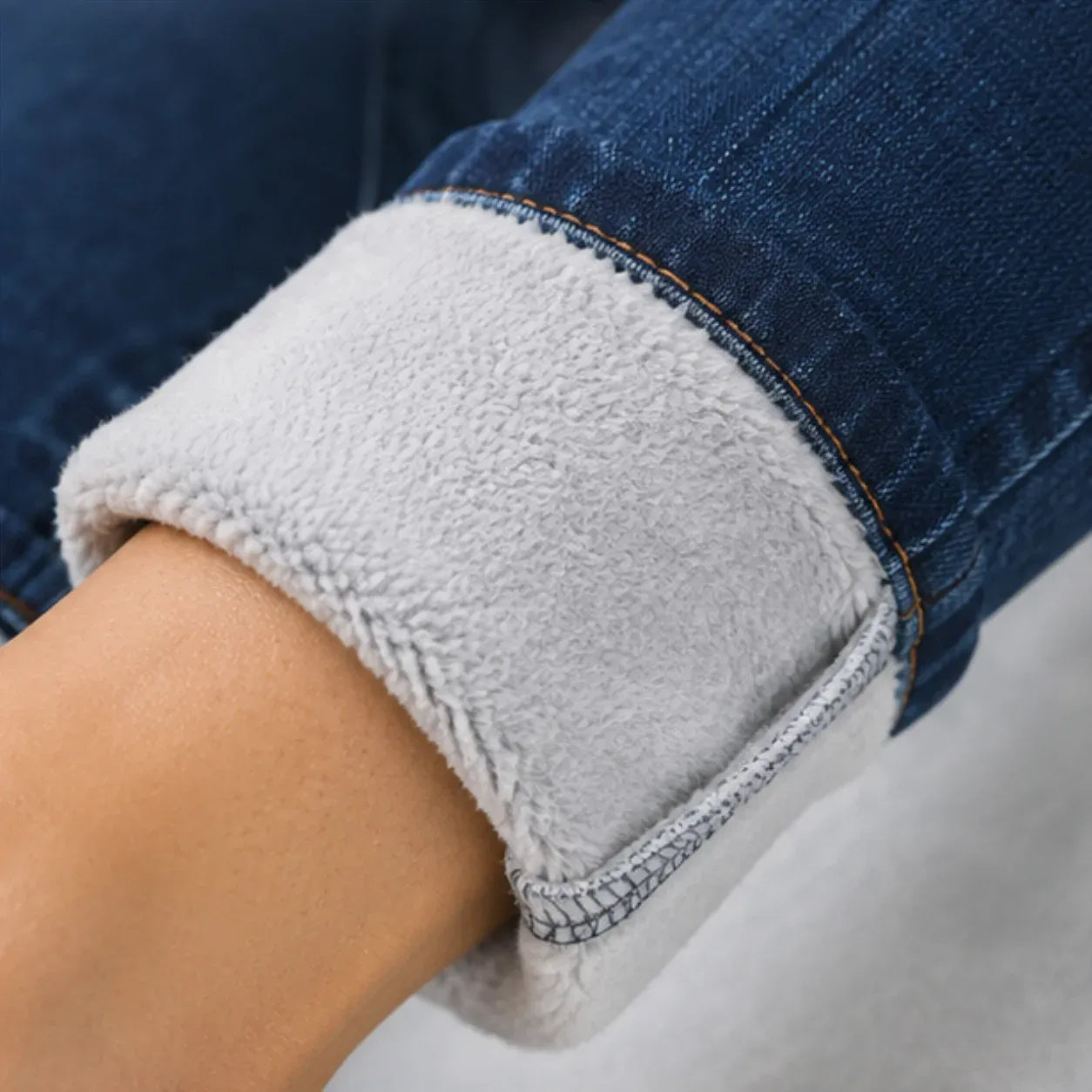 Close-up of the soft fleece lining inside blue fleece-lined mid-rise skinny jeans