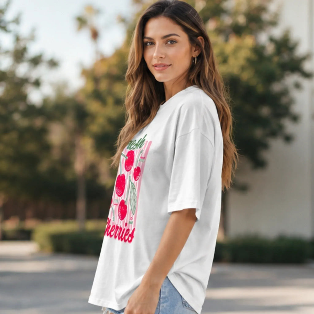 Side view of the Fresh Cherries Graphic Oversized T-Shirt in white featuring a relaxed oversized fit.