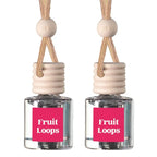 Two small clear glass reed diffusers with pink labels reading 'Fruit Loops' and light wood tops with braided beige cords, shown on a white background.