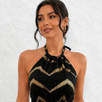 Close-up detail of the Chevron Halter Neck Romper in black highlighting the halter neckline and metallic gold chevron pattern.