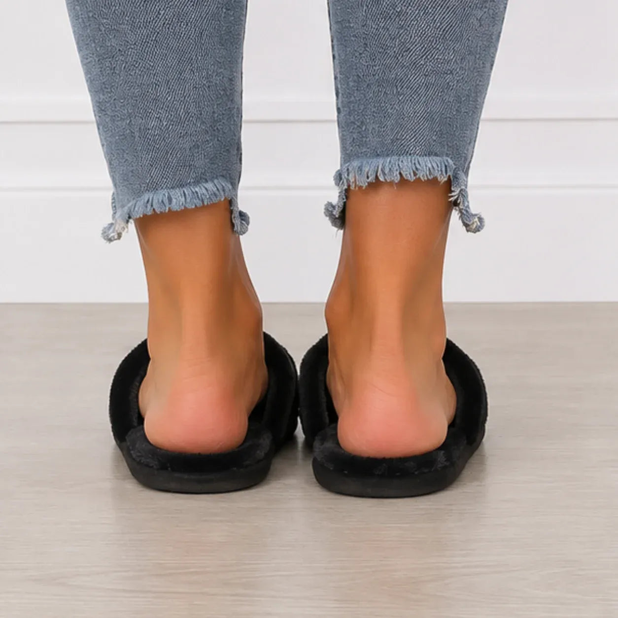 Back view of black Heart Plush House Slippers with soft faux fur lining and open-back indoor slide design.
