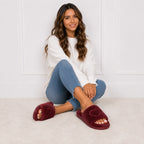 Woman wearing wine red Heart Plush House Slippers with plush faux fur and embroidered heart detail.