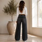 Back view of High Waist Distressed Wide Leg Black Jeans displaying the high-rise waistband, classic back pockets, and full wide-leg fit.