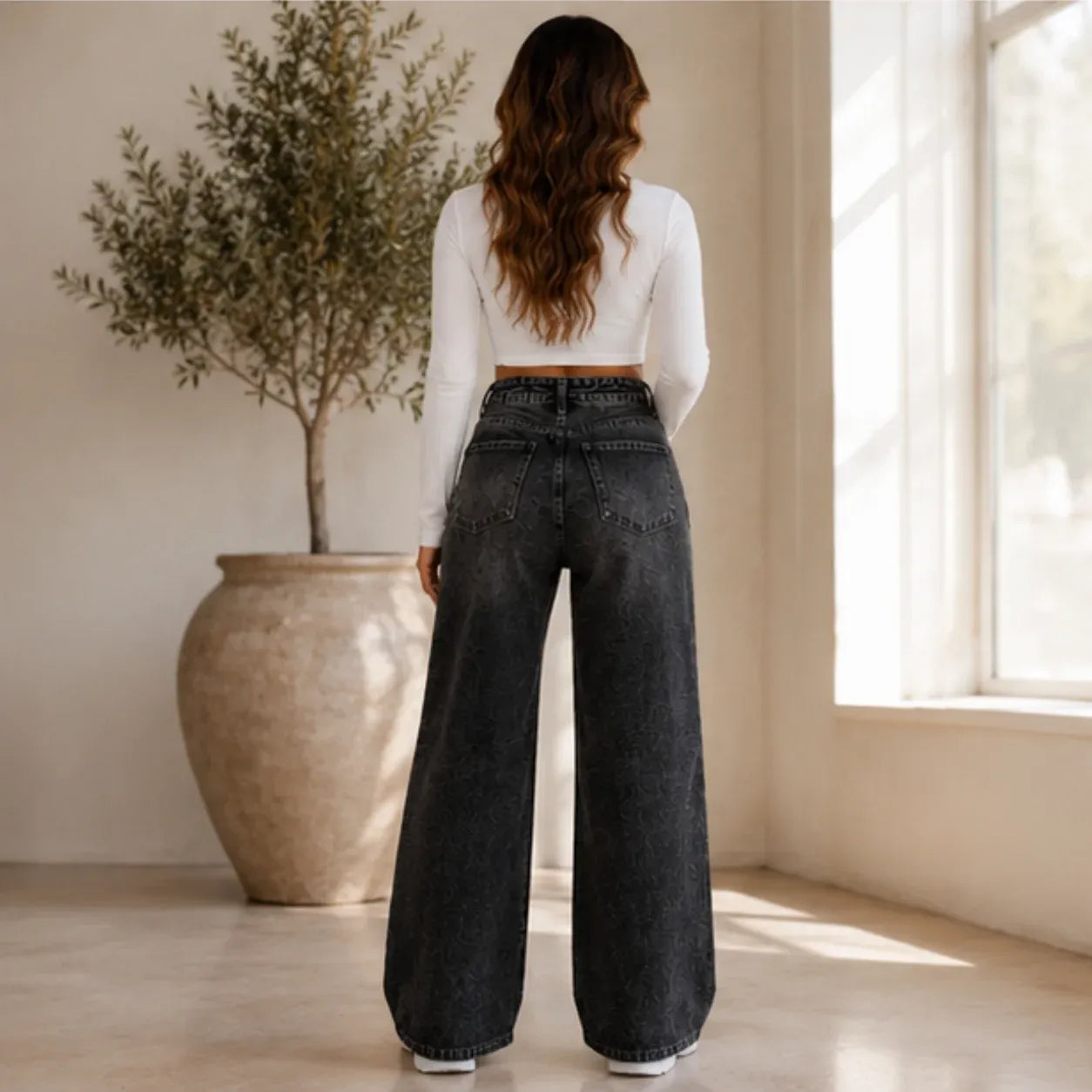 Back view of High Waist Distressed Wide Leg Black Jeans displaying the high-rise waistband, classic back pockets, and full wide-leg fit.
