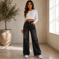 Front view of a model wearing High Waist Distressed Wide Leg Black Jeans featuring a high-rise fit, distressed knees, and a relaxed wide-leg silhouette.