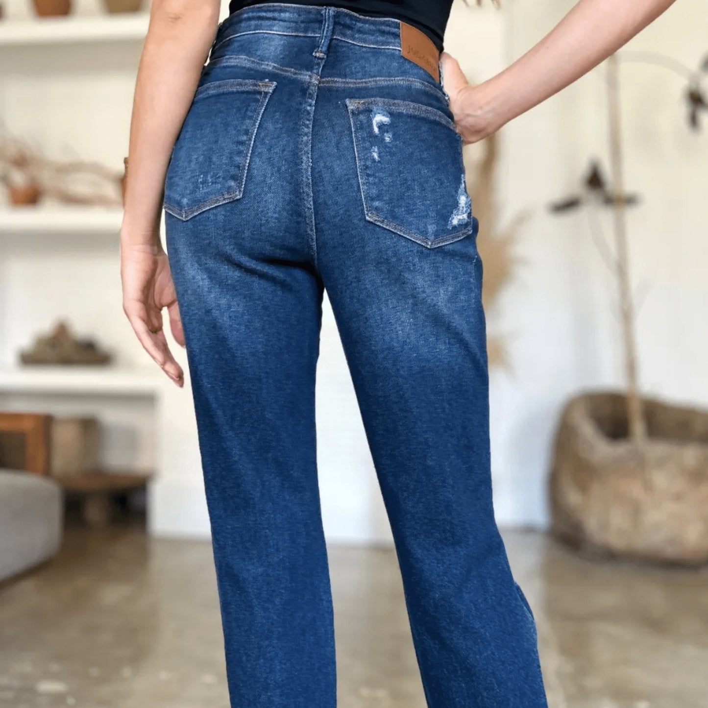 Alternate angle of a person wearing high-waist straight-leg jeans.