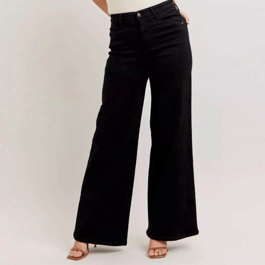 Frontal view of high-waisted black wide-leg jeans highlighting the cinched waist.