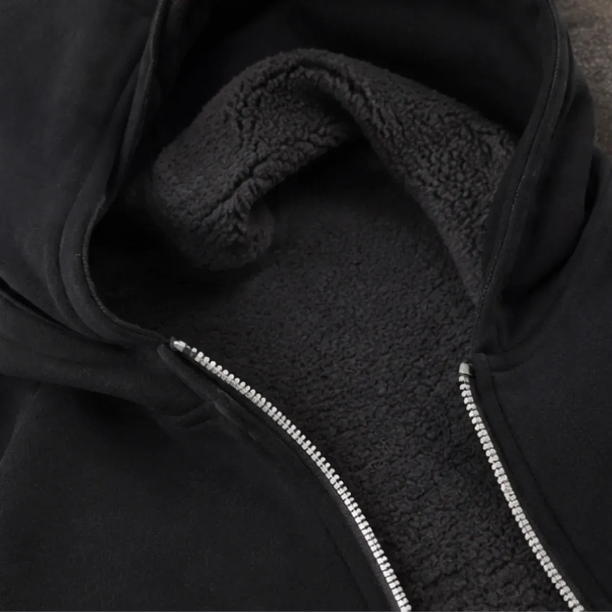 Hooded fleece-lined zip-up sweatshirt showing soft fleece interior lining and zipper detail