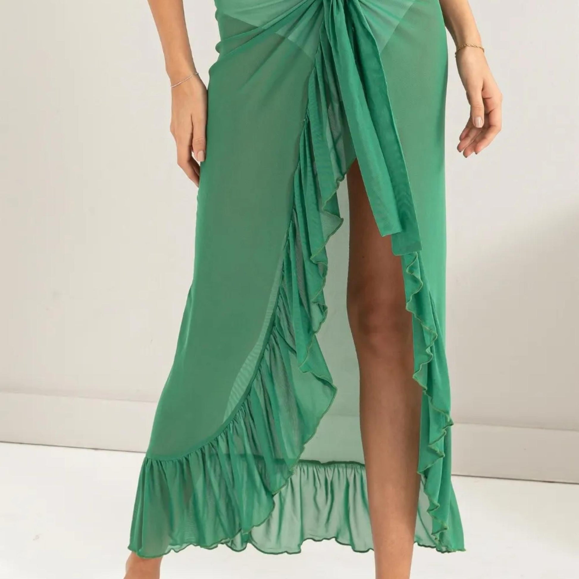 Lifestyle view of the HYFVE Green ruffled skirt styled for a beach outing.