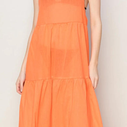 Detail view of the tiered skirt design on the HYFVE Orange maxi dress.