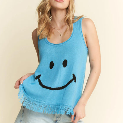 Close-up of the smiley face design on the turquoise fringe tank.