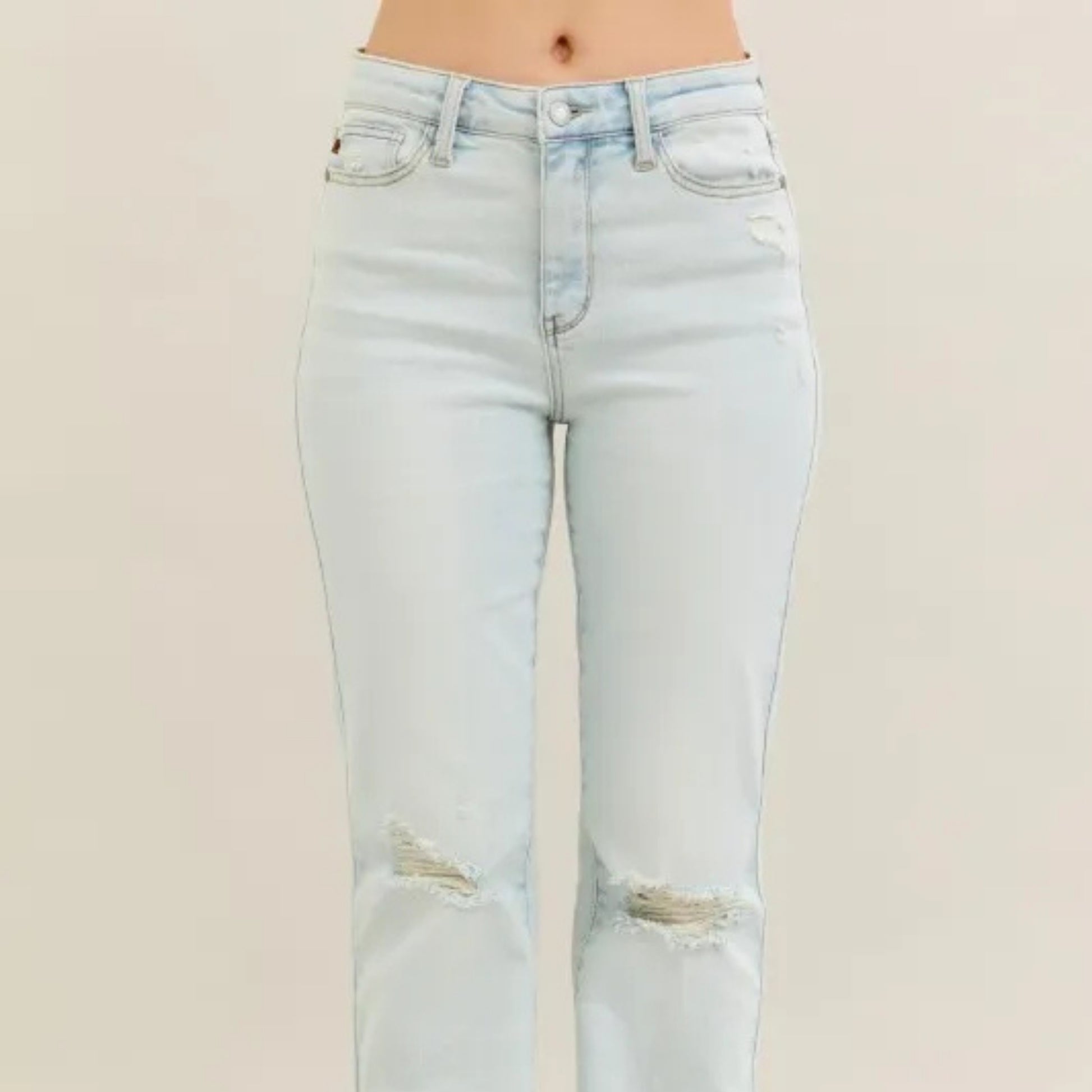 Full view of the distressed medium wash bootcut jeans.