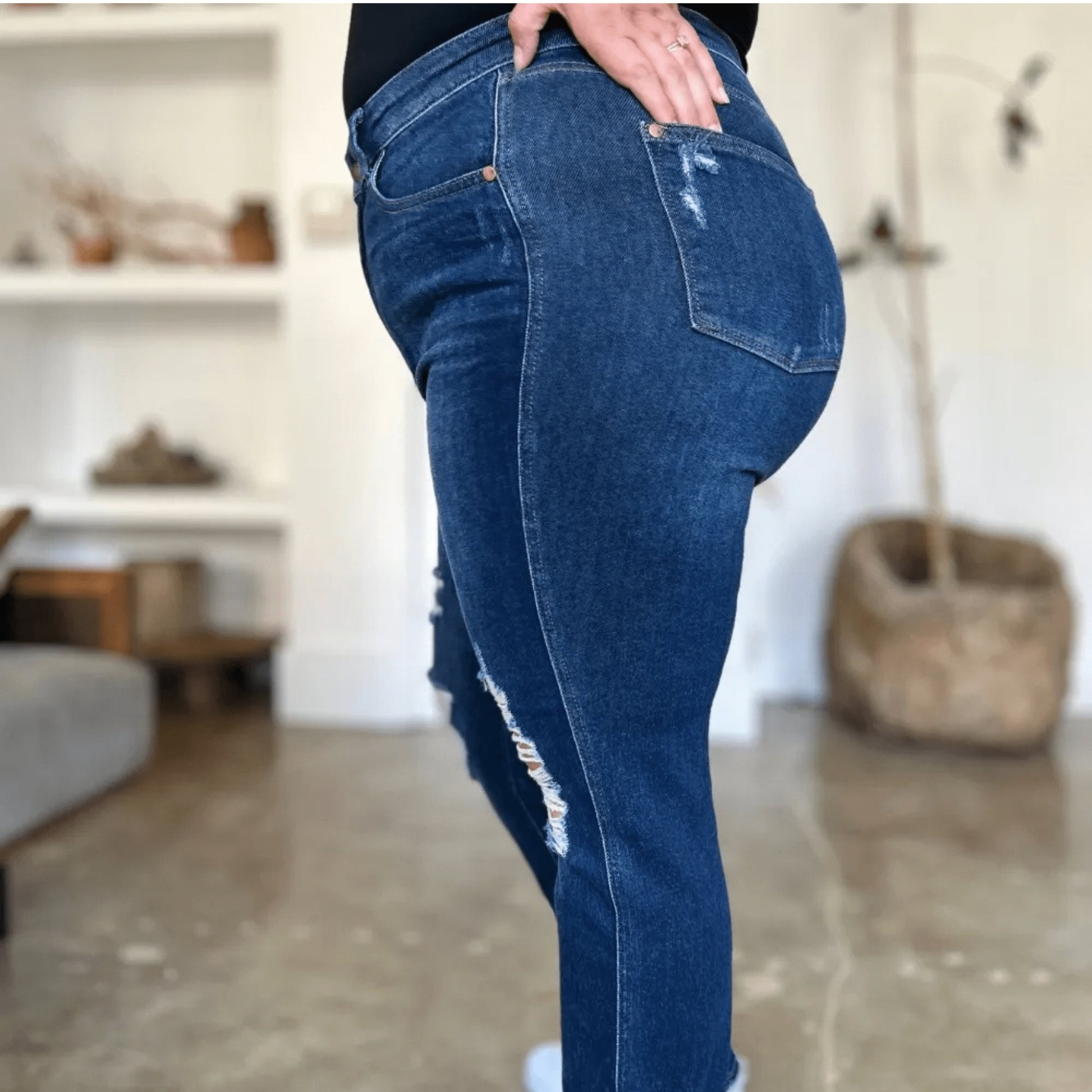 Lifestyle view of a person wearing Judy Blue distressed straight jeans.