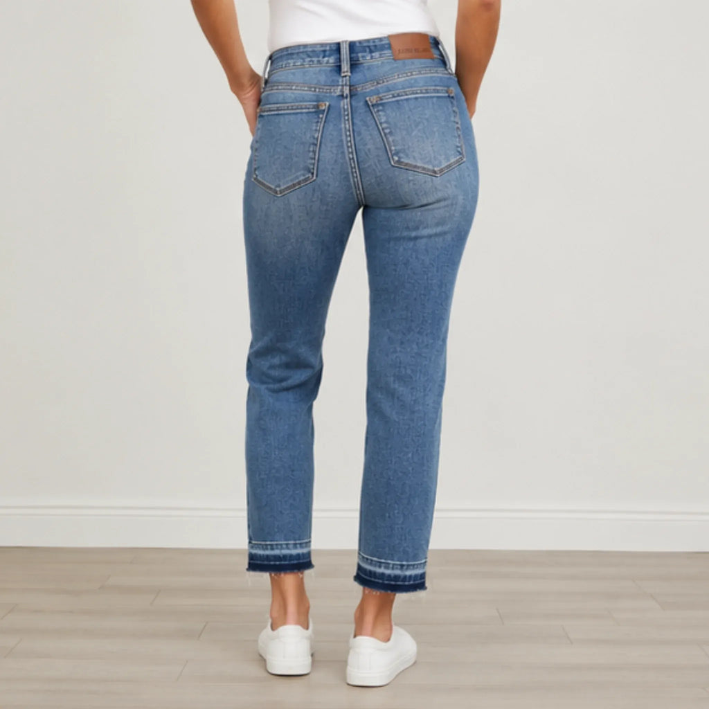 Back view of Judy Blue Full Size Mid Rise Rigid Magic Release Hem Jeans highlighting the flattering rear fit, pockets, and release hem finish.