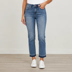 Woman wearing Judy Blue Full Size Mid Rise Rigid Magic Release Hem Jeans with a flattering straight-leg fit and release hem in medium wash denim.