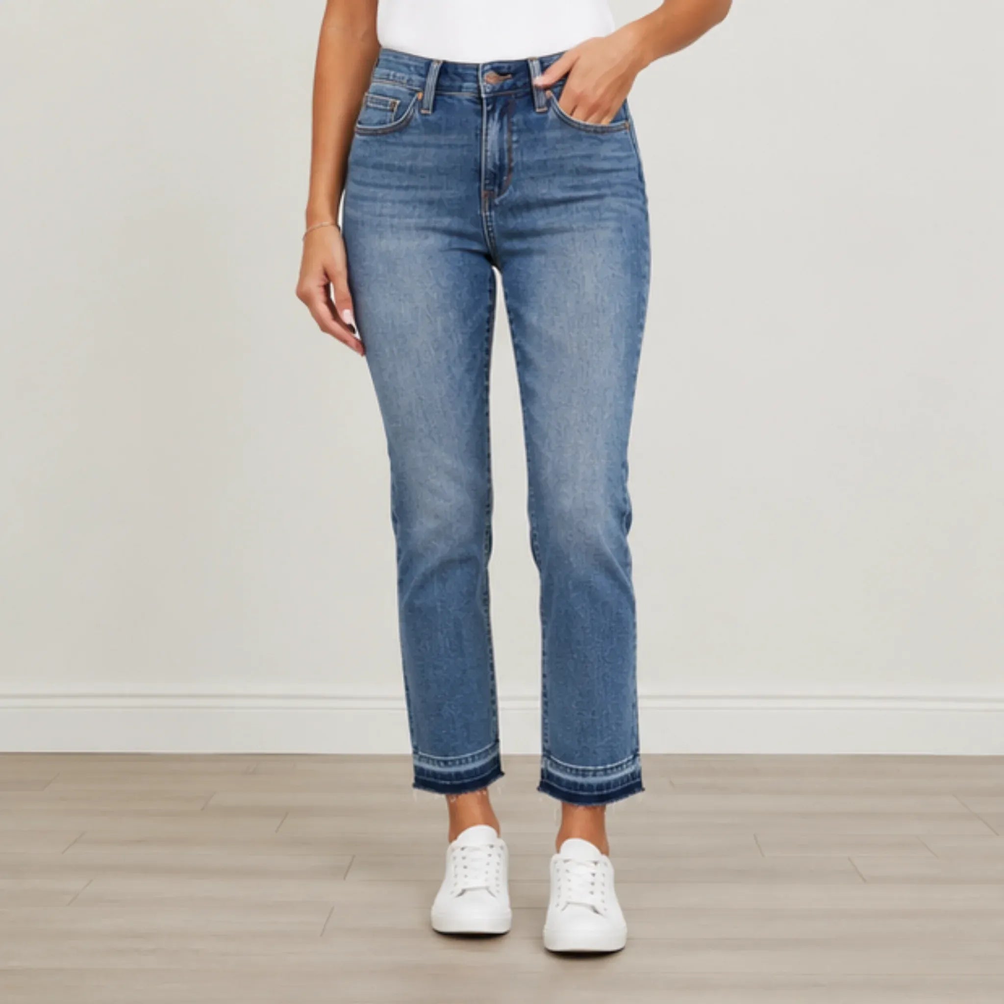 Woman wearing Judy Blue Full Size Mid Rise Rigid Magic Release Hem Jeans with a flattering straight-leg fit and release hem in medium wash denim.