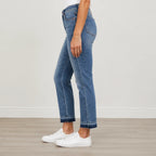 Side view of Judy Blue Full Size Mid Rise Rigid Magic Release Hem Jeans showcasing the mid-rise waist, structured fit, and release hem detail.