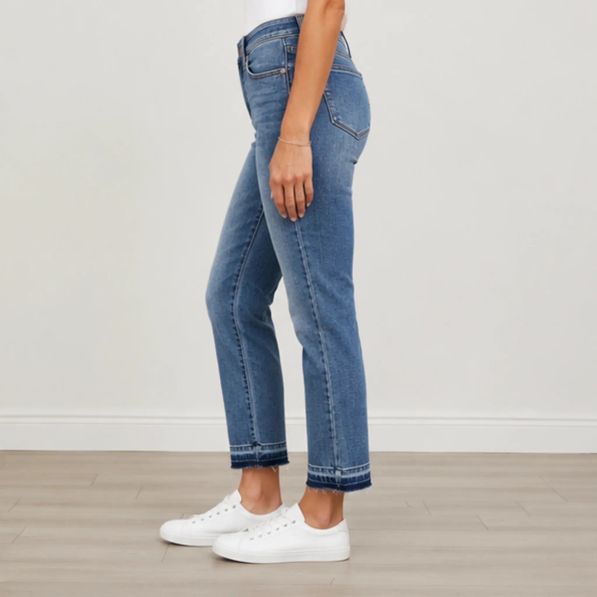 Side view of Judy Blue Full Size Mid Rise Rigid Magic Release Hem Jeans showcasing the mid-rise waist, structured fit, and release hem detail.