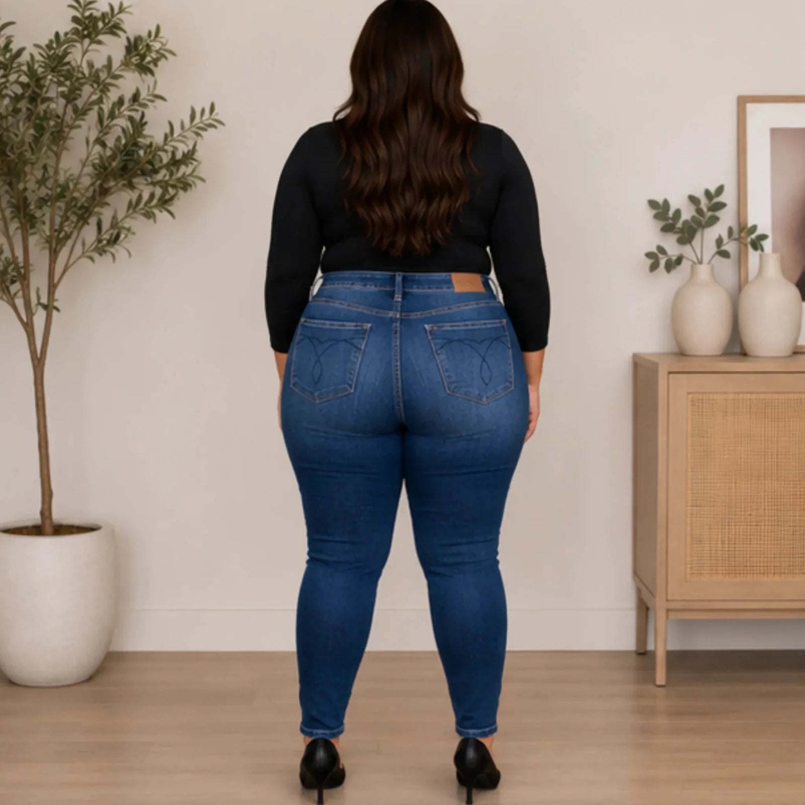 Back view of women's Judy Blue Plus Size Washed Thermal Skinny Jeans featuring signature stitched back pockets, medium wash denim, and a flattering skinny silhouette.