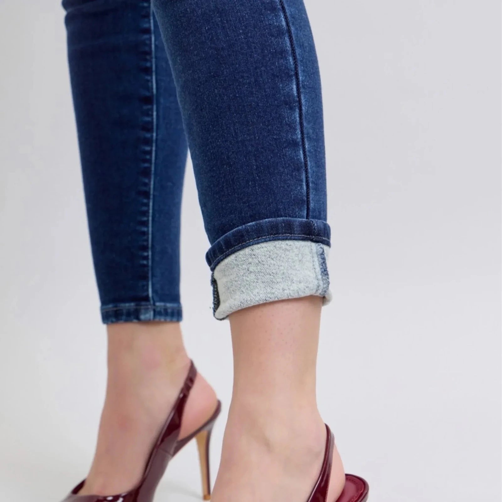 Close-up of Judy Blue thermal-lined skinny jeans cuff showing the soft brushed thermal interior and premium medium wash denim for added warmth.