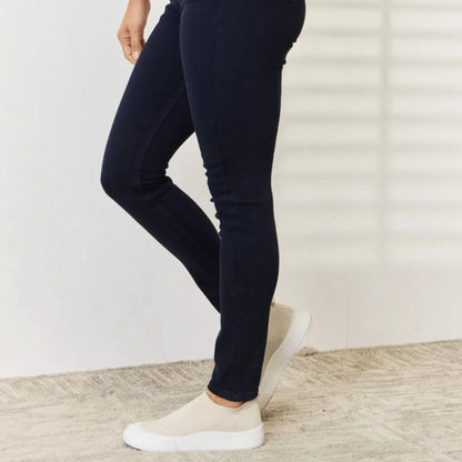 Side view showcasing the slimming fit of the navy skinny jeans.