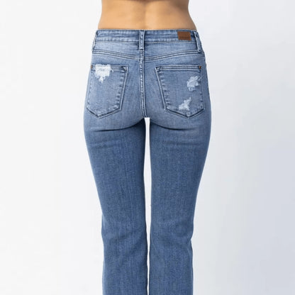 Close-up view of the distressing and texture of Judy Blue straight leg jeans.