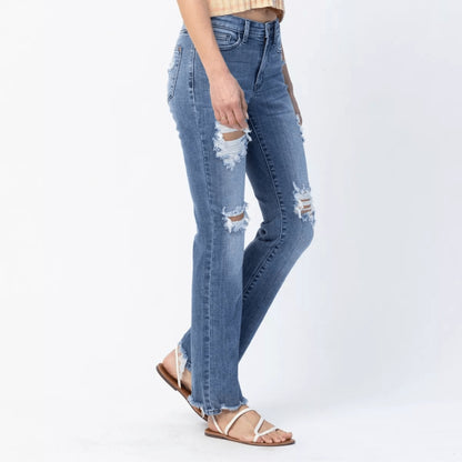Side view of Judy Blue destroyed straight jeans showing the raw hem and fit.