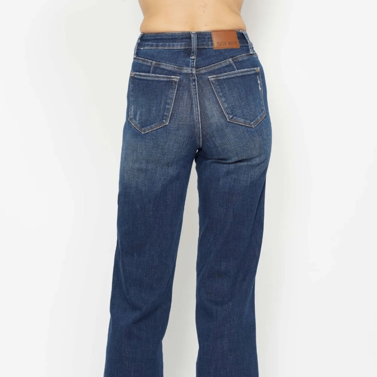 Back view of dark wash tummy control skinny jeans showing pocket detail.