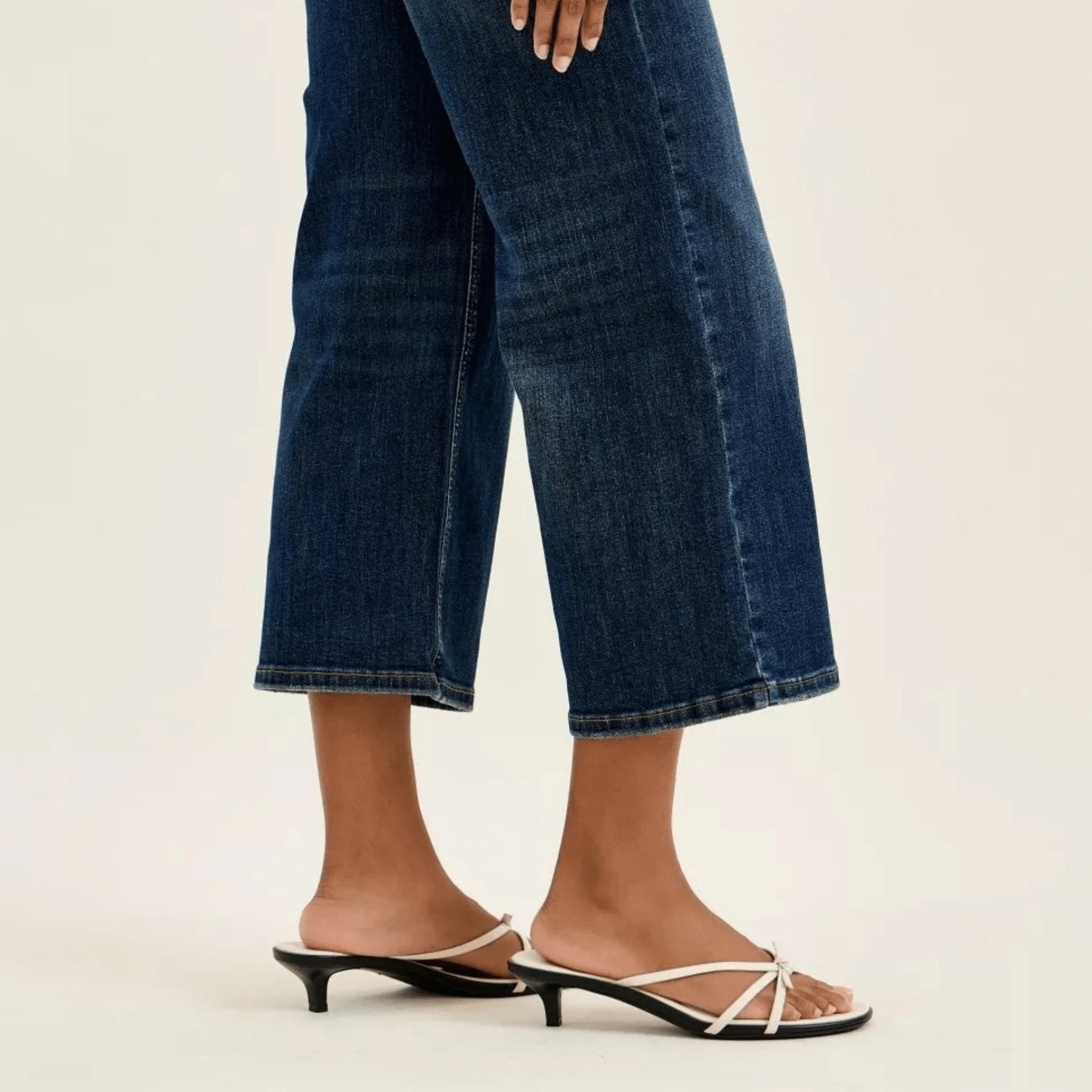 Close-up of wide-crop utility jeans styled with a white top.