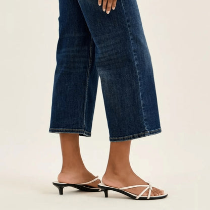 Close-up of wide-crop utility jeans styled with a white top.