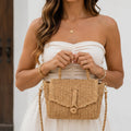 Khaki Faux Straw Weaved Clutch Bag styled with a white summer dress by Solazura Boutique.