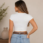 Back view of the Kick Dust Stay Gold Western Graphic Crop Tee featuring a classic crew neckline, short sleeves, and fitted cropped design.