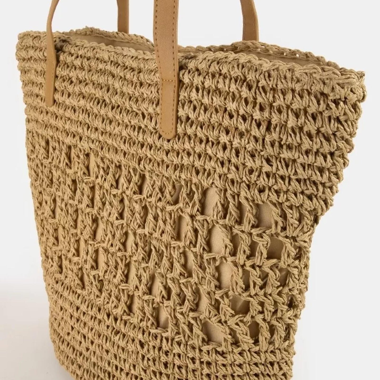 Side profile of the Fame large straw tote bag highlighting the wide 5.5-inch base for extra storage.