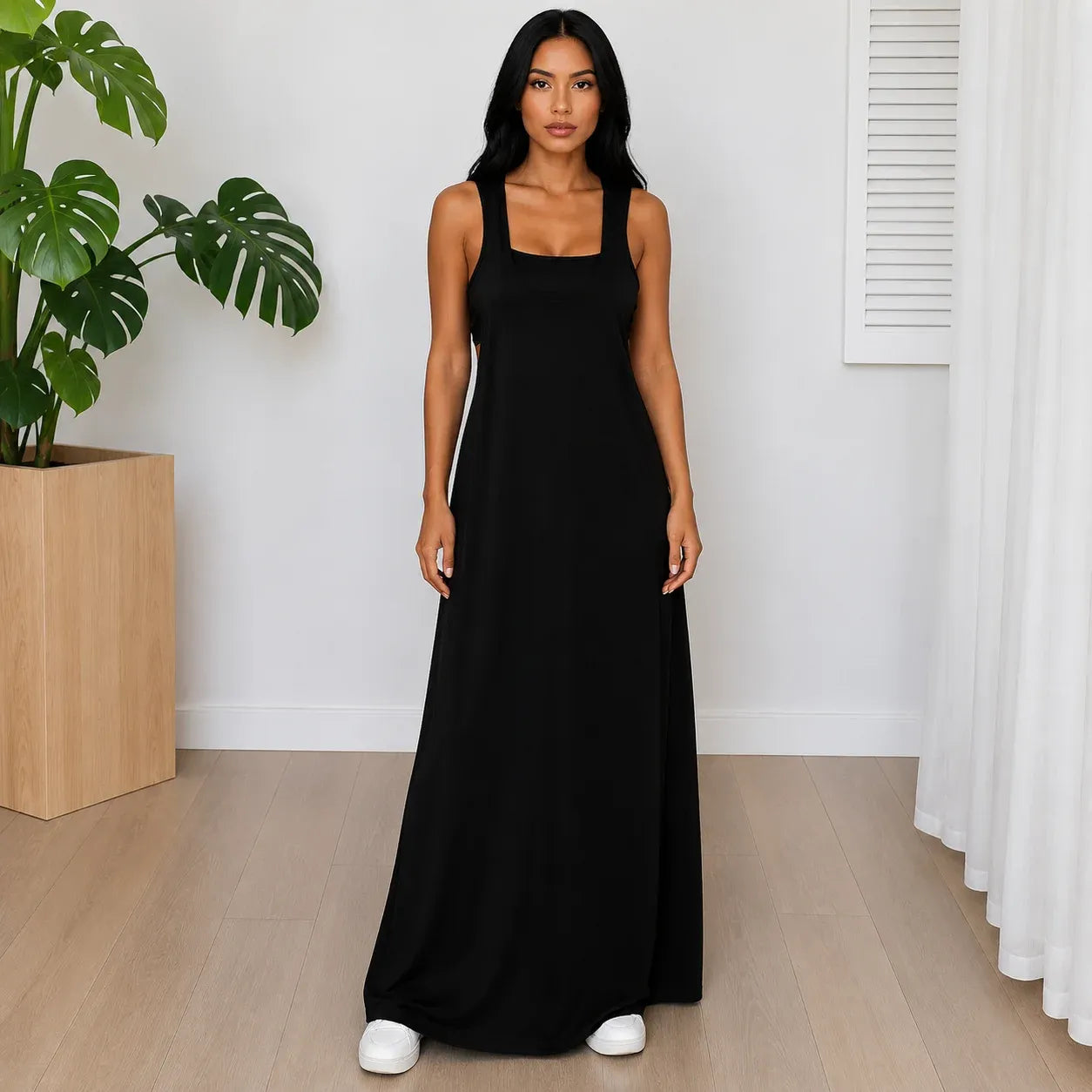 Woman wearing the Layered Sleeveless Maxi Dress Set in black featuring a casual sleeveless layered maxi dress design.