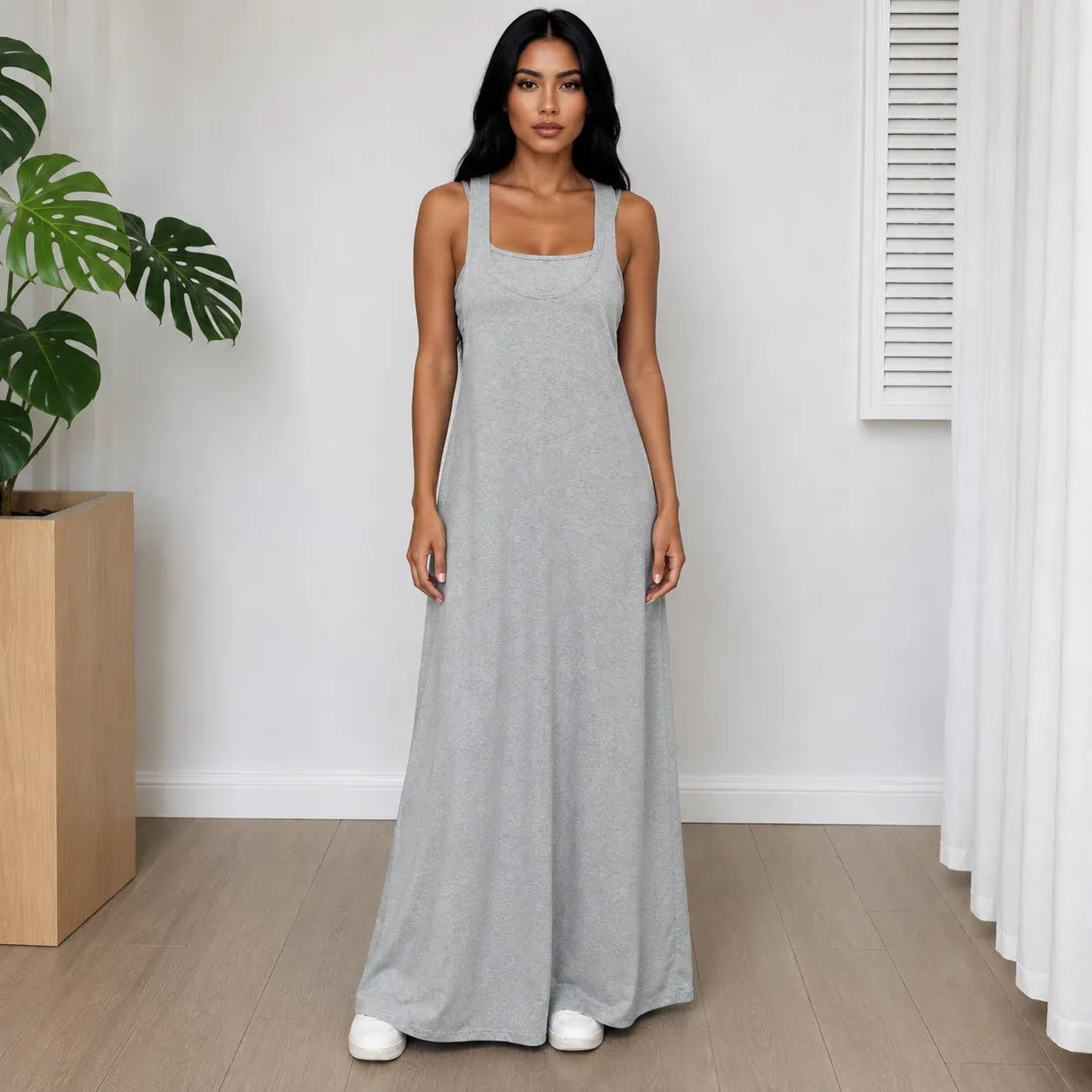 Woman wearing the Layered Sleeveless Maxi Dress Set in light gray with a relaxed fit and flowing maxi dress.