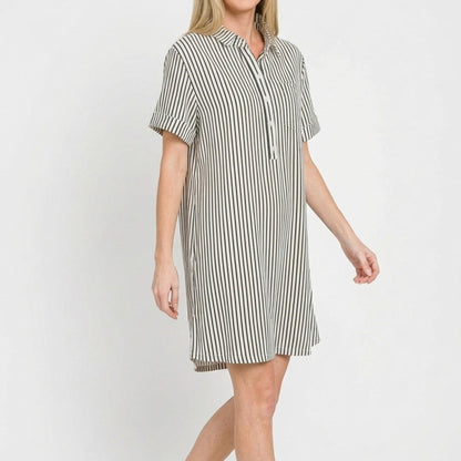 Lifestyle view of the Black striped collared dress styled for a chic, casual coastal look.