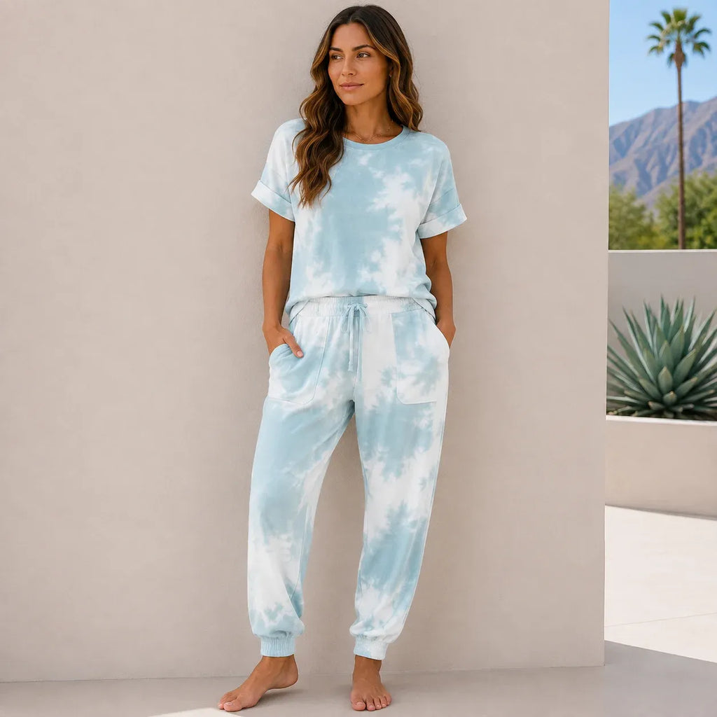Women's light blue tie-dye lounge set with soft short sleeve top and relaxed jogger pants.